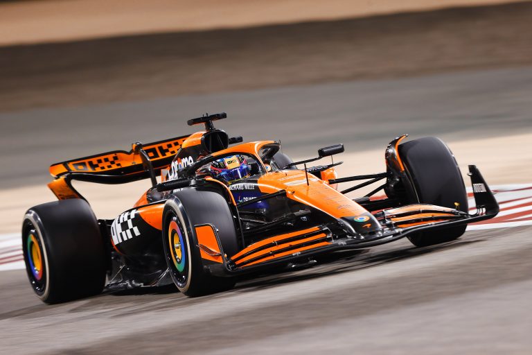 Photo of the McLaren MCL38 F1 car speeding around a racing track