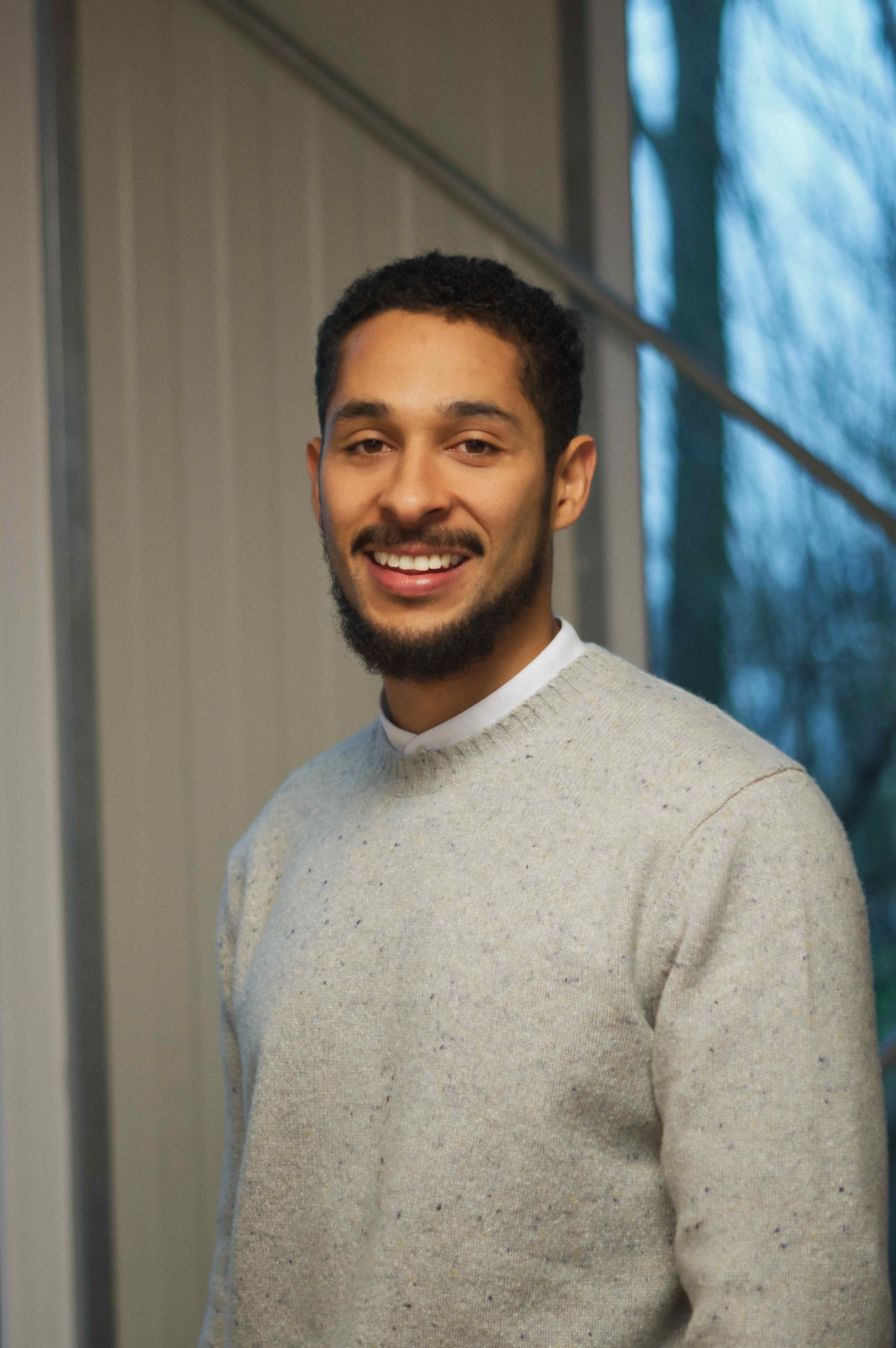 A portrait photo of Olivier Lugier wearing a grey sweater 